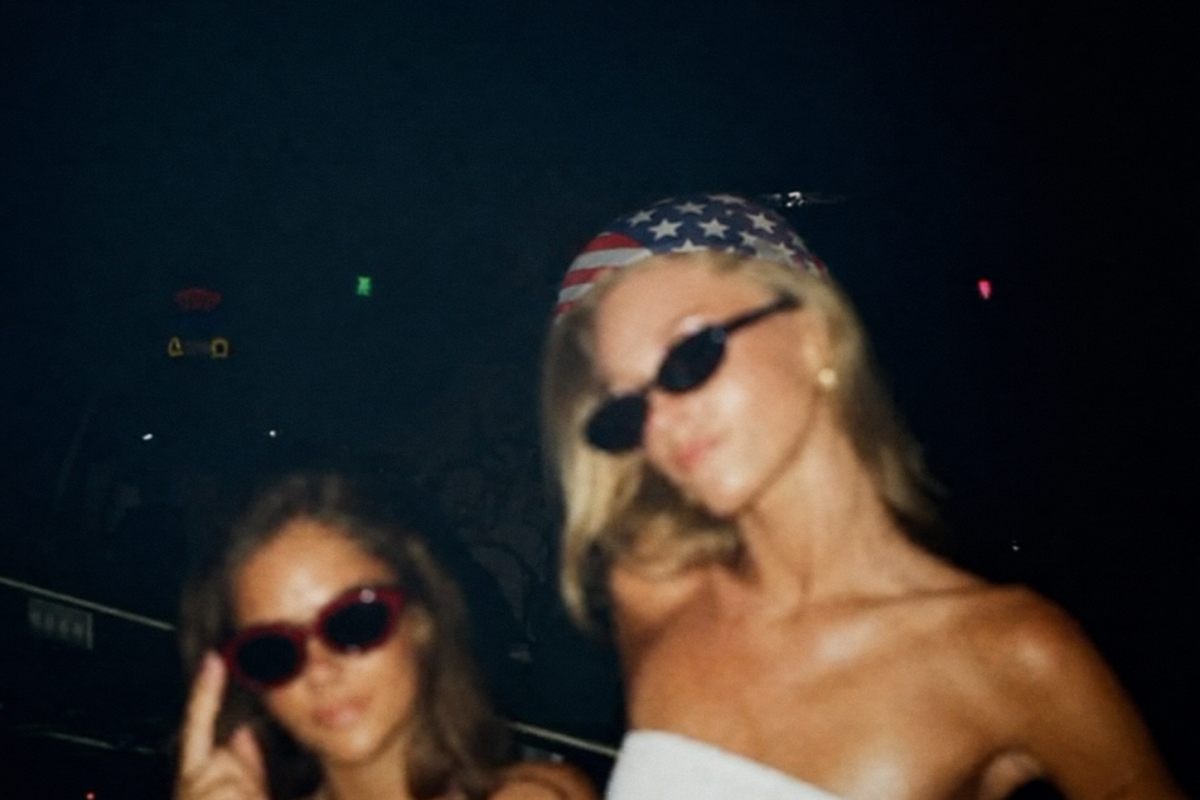 2 girls wearing sunglasses dressed patriotically at a july 4th bar crawl