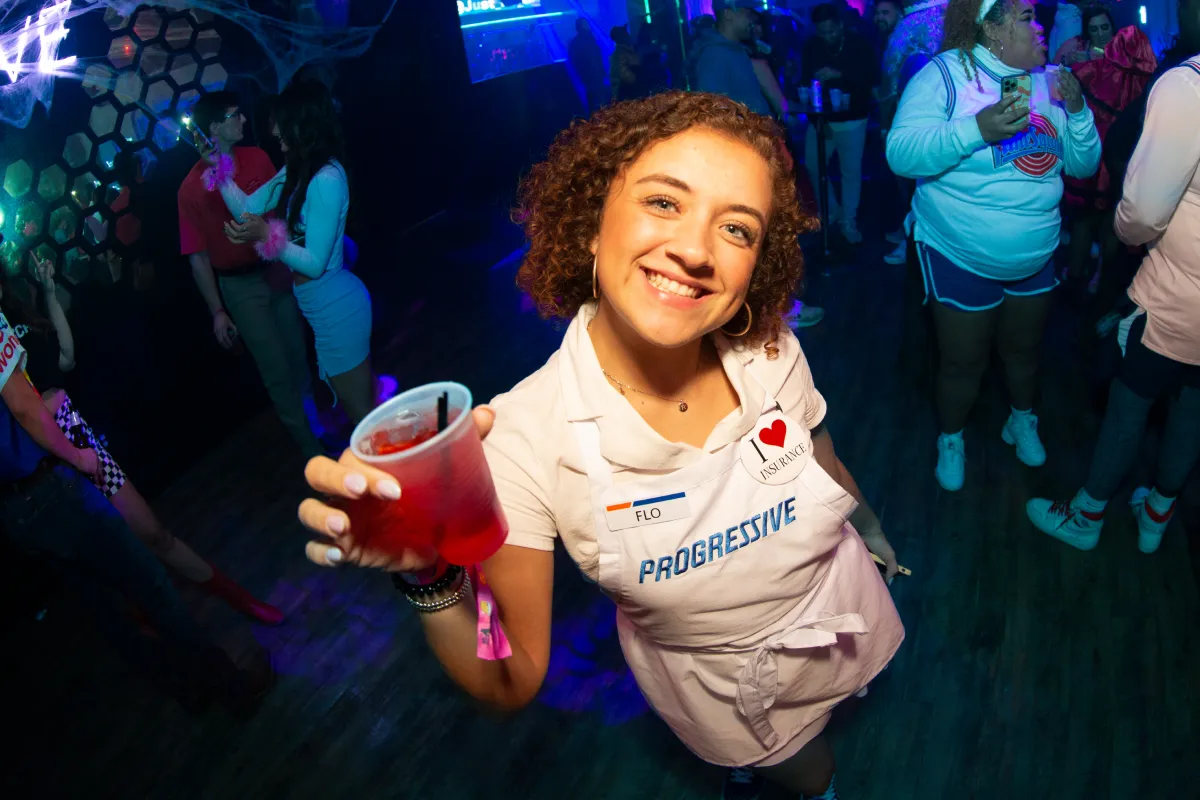girl shows off her flo from progressive halloween costume during the halloween bar crawl