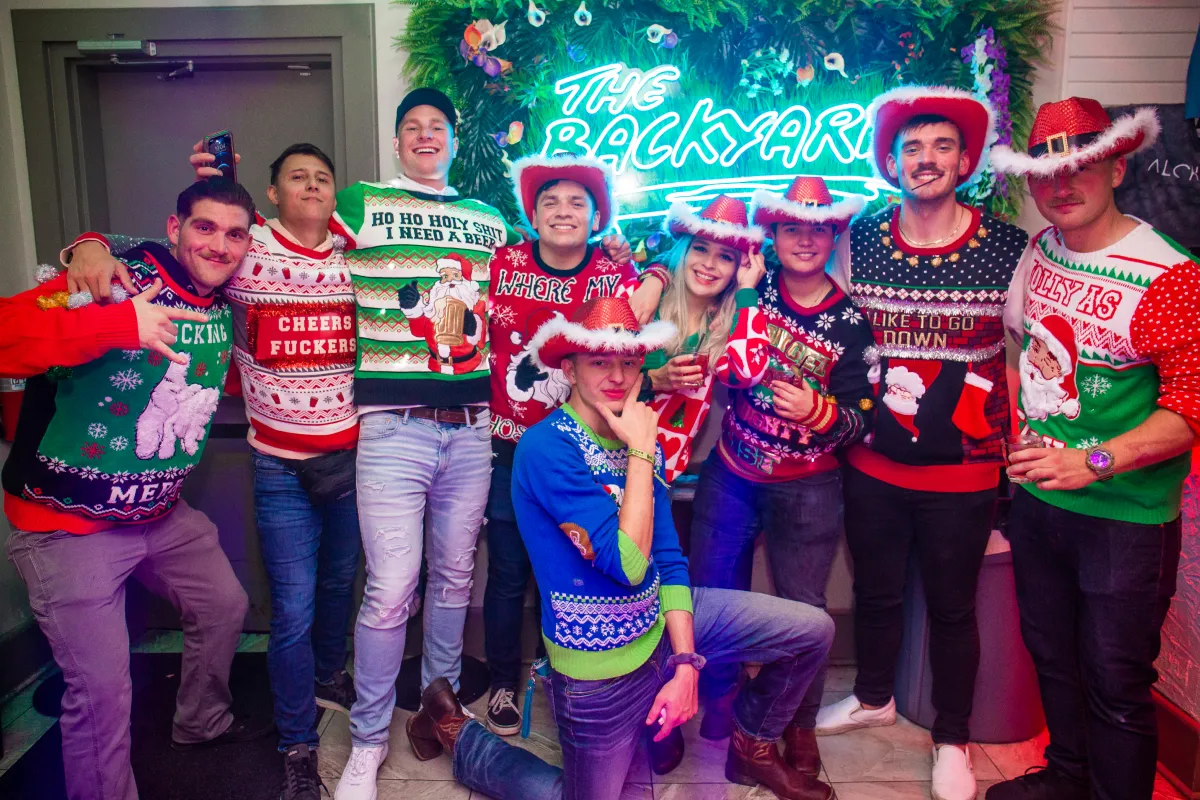 Group wearing ugly sweters at the ugly sweater christmas crawl