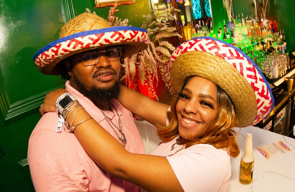 a couple in sombreros at the 2023 tacos and tequilla bar crawl