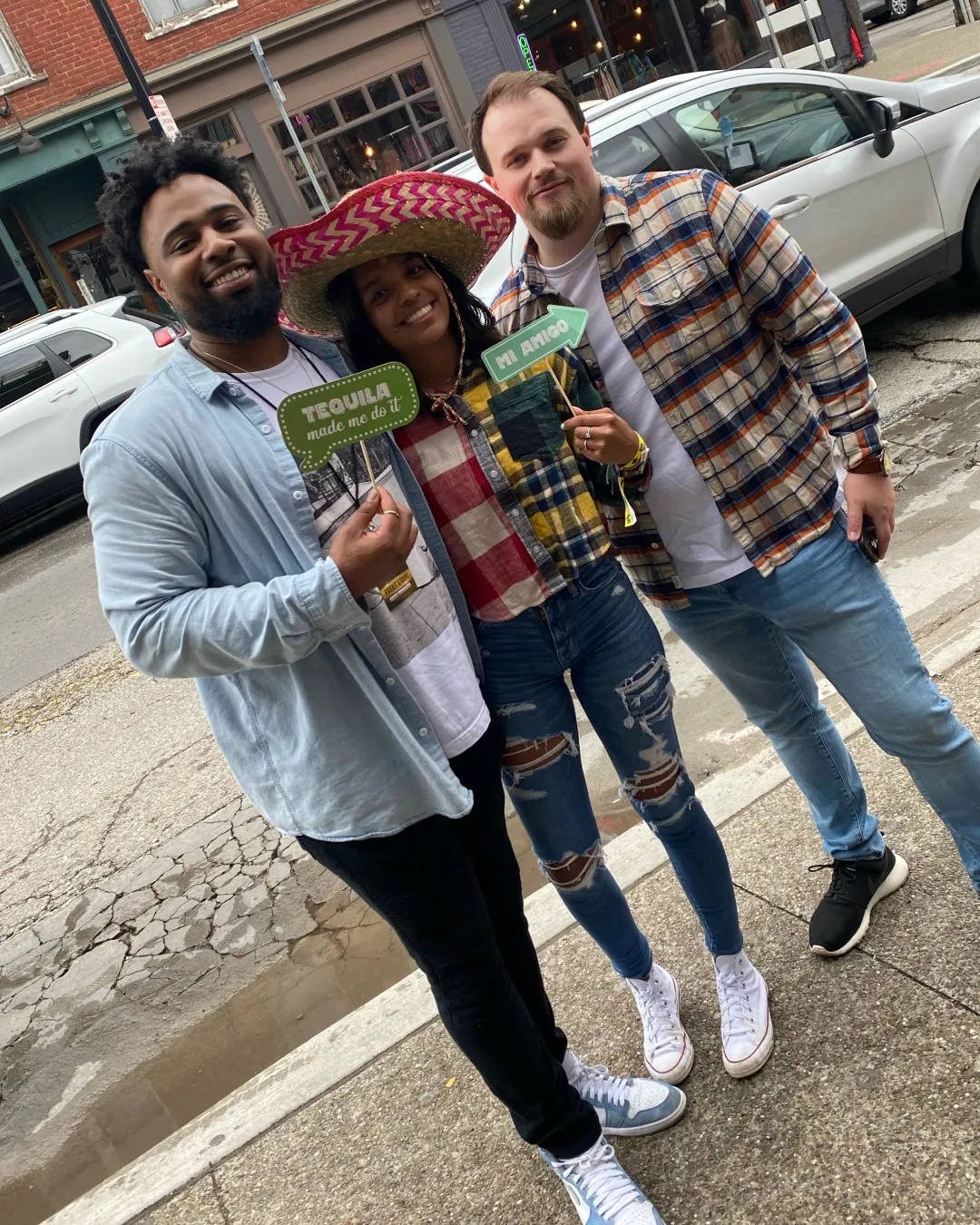 3 festive individuals gather outside one of the best bars in Pittsburgh checking in for the Tacos and Tequila Bar Crawl