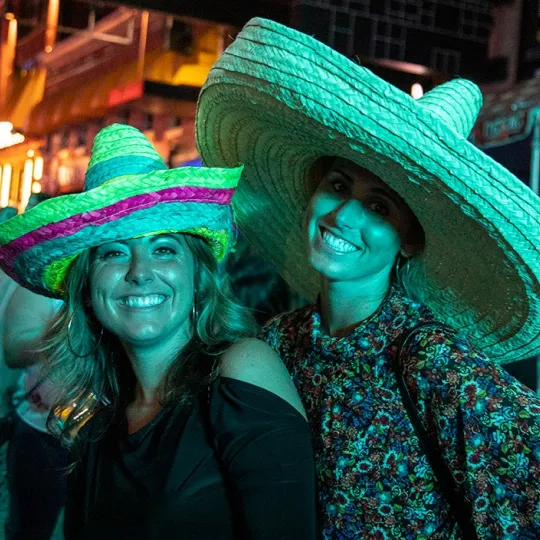Animated conversations and laughter as girls in colorful sombreros savor every moment of the Tacos and Tequila extravaganza.
