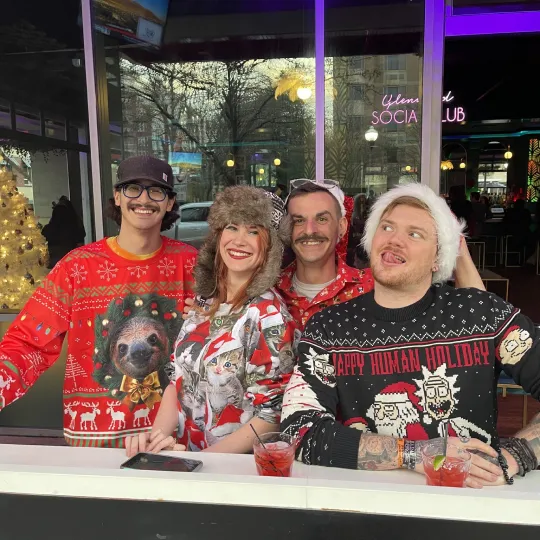 Festive folks feeling the holiday spirit during the ugly sweater bar crawl.