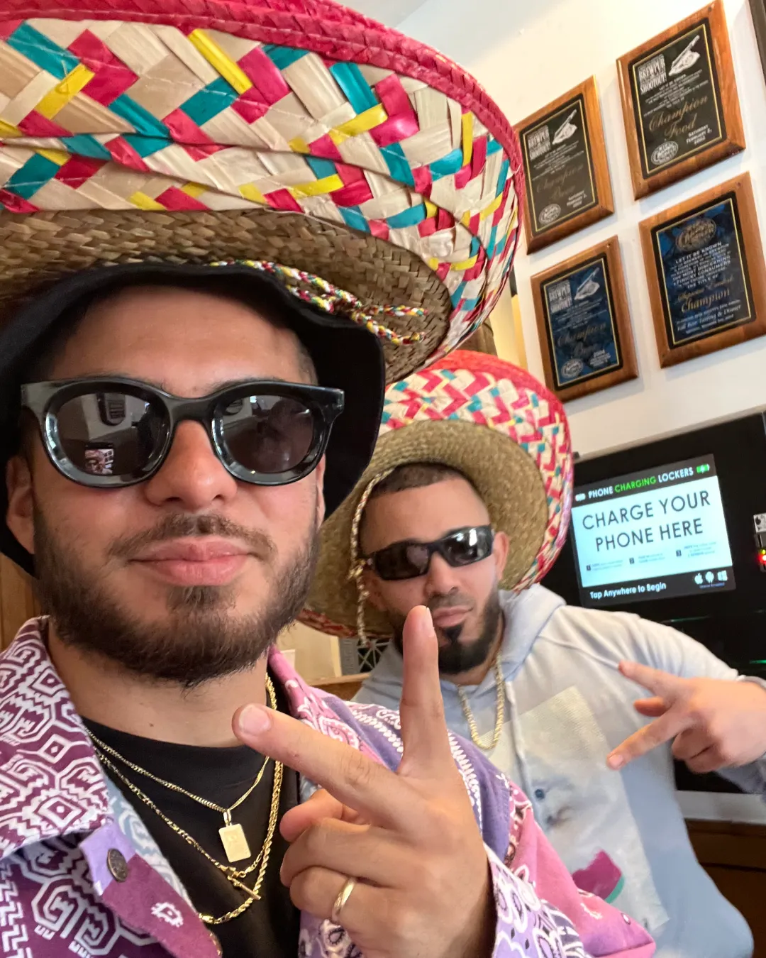 Elated friends in matching sombreros, pose for a selfie and take in the energy of the tacos and tequila bar event