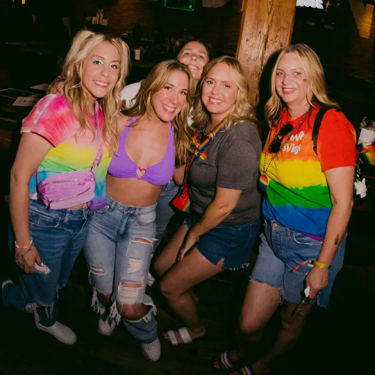 A splash of rainbow colors as three friends enjoy the Pride Bar Crawl and celebrate diversity!

