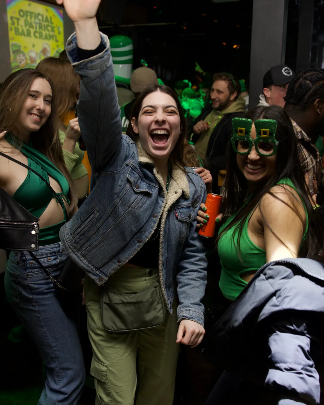 Group of girlfriends decked out in their most glamorous green showcasing their festive spirit making every moment count at the St. Patrick's Day bar hop in Cleveland
