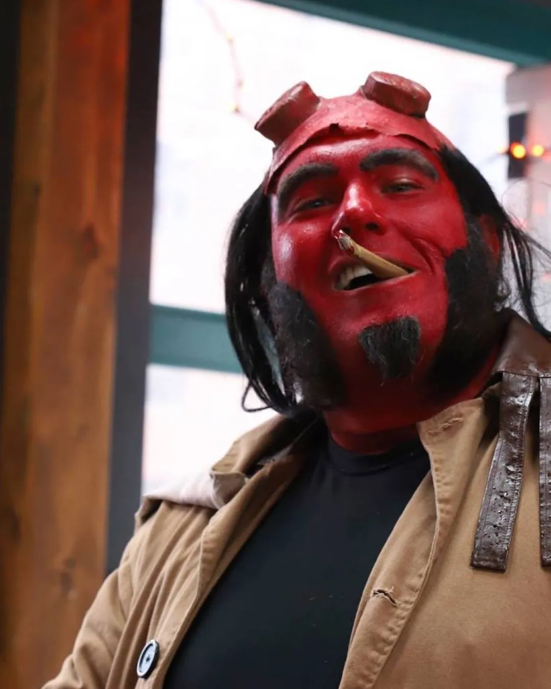 Amidst the energy, a Halloween Hellboy costume captures the essence of the night, mesmerizing onlookers with his happy smile during the Halloween bar crawl

