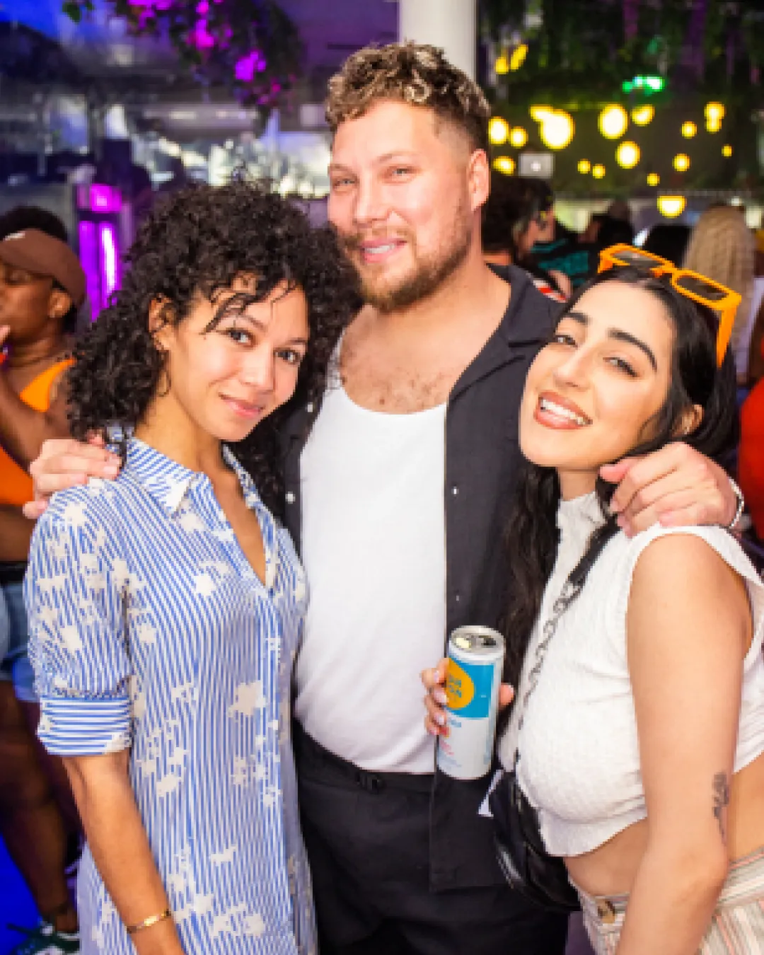 3 friends showing their love and living their best life at the Pride Bar Crawl