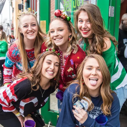 Santa's helpers gone wild: ugly sweater enthusiasts on their merry bar crawl.