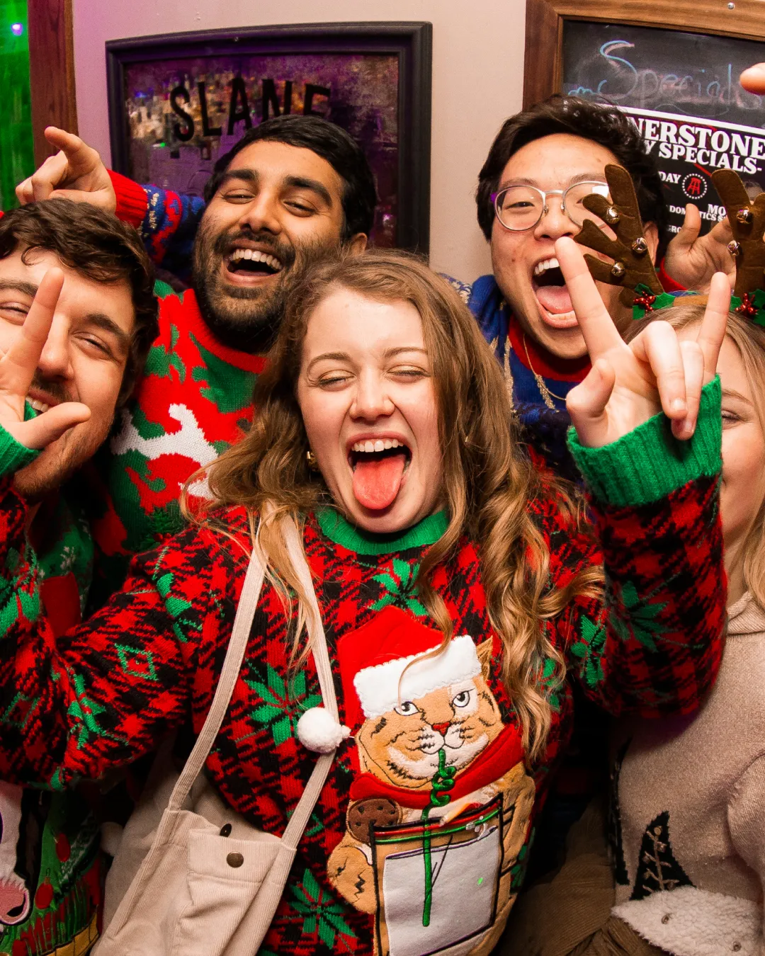 Tacky sweaters and great times: bar crawl crew in holiday mode.