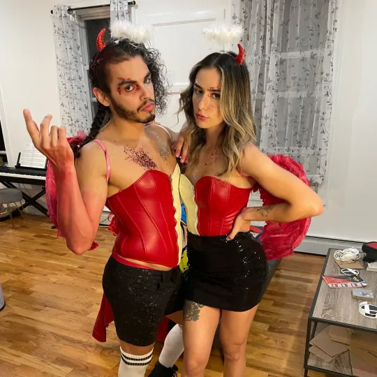 2 friends show off their devil halloween costumes for the halloween bar crawl