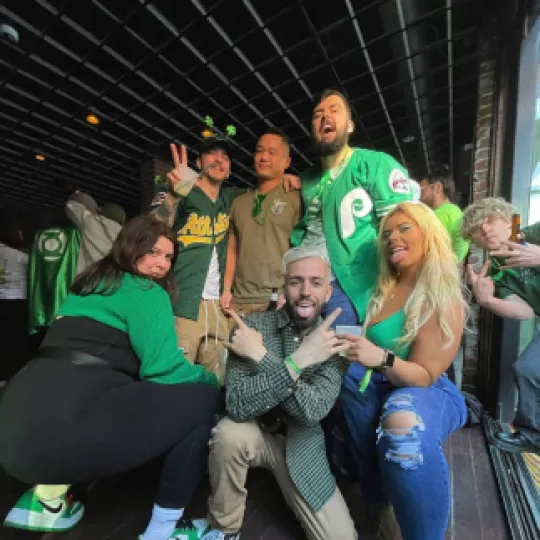 A group of friends posing towards the camera during the Philly St Pats bar crawl