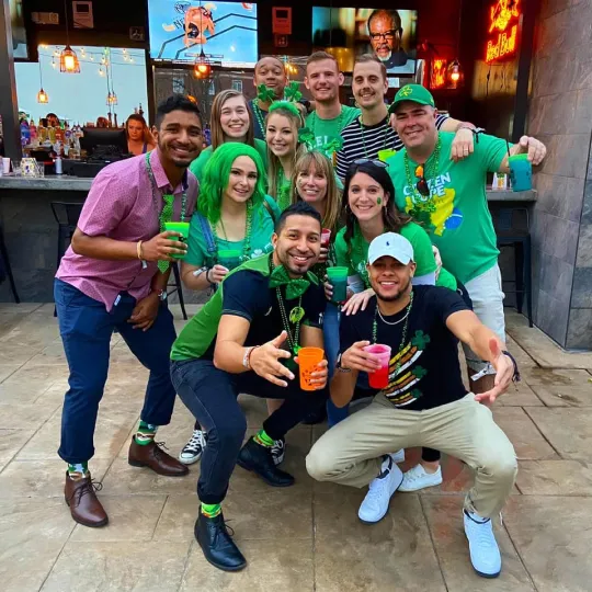 Ecstatic group, their festive outfits a blend of tradition and fun, painting the bar crawl with shades of St. Patrick's Day delight
