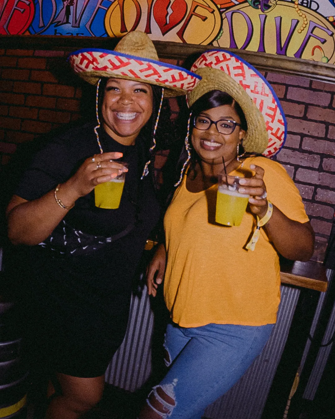 Gleeful girls in striking sombreros, creating a whirl of colors and laughter amidst the Tacos and Tequila bar crawl scene 
