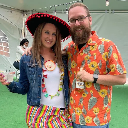 Stylish and festive couple captured in their cinco de mayo themed outfits  amidst the pulsating energy of the best bar in Raleigh