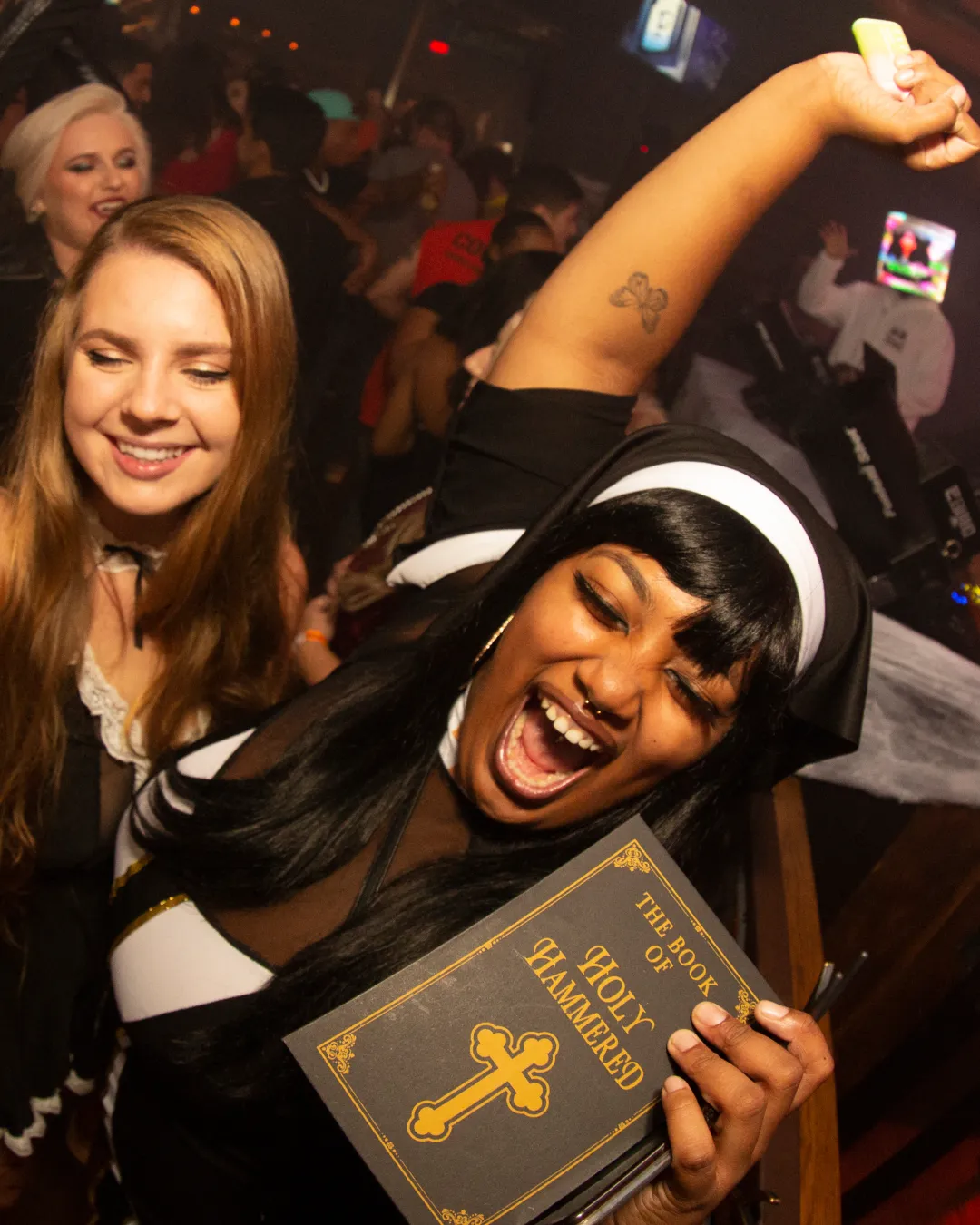 Amid the haunting melodies, a comical nun is found dancing in desguise amongst a group of friends at the Halloween bar crawl
