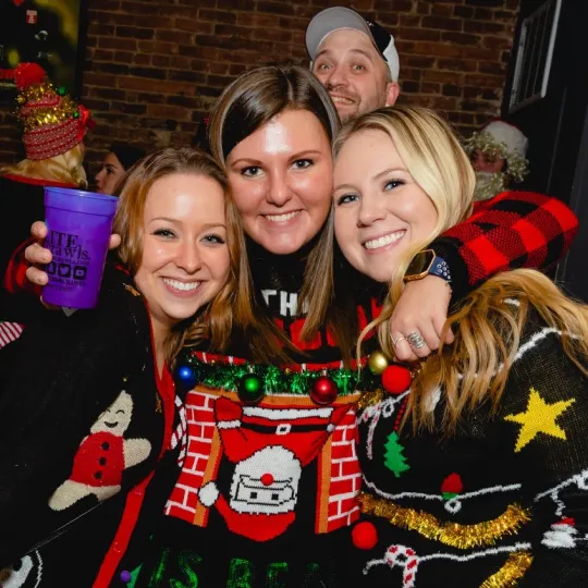 Ugly sweaters, beautiful moments: friends making memories at the bar crawl.