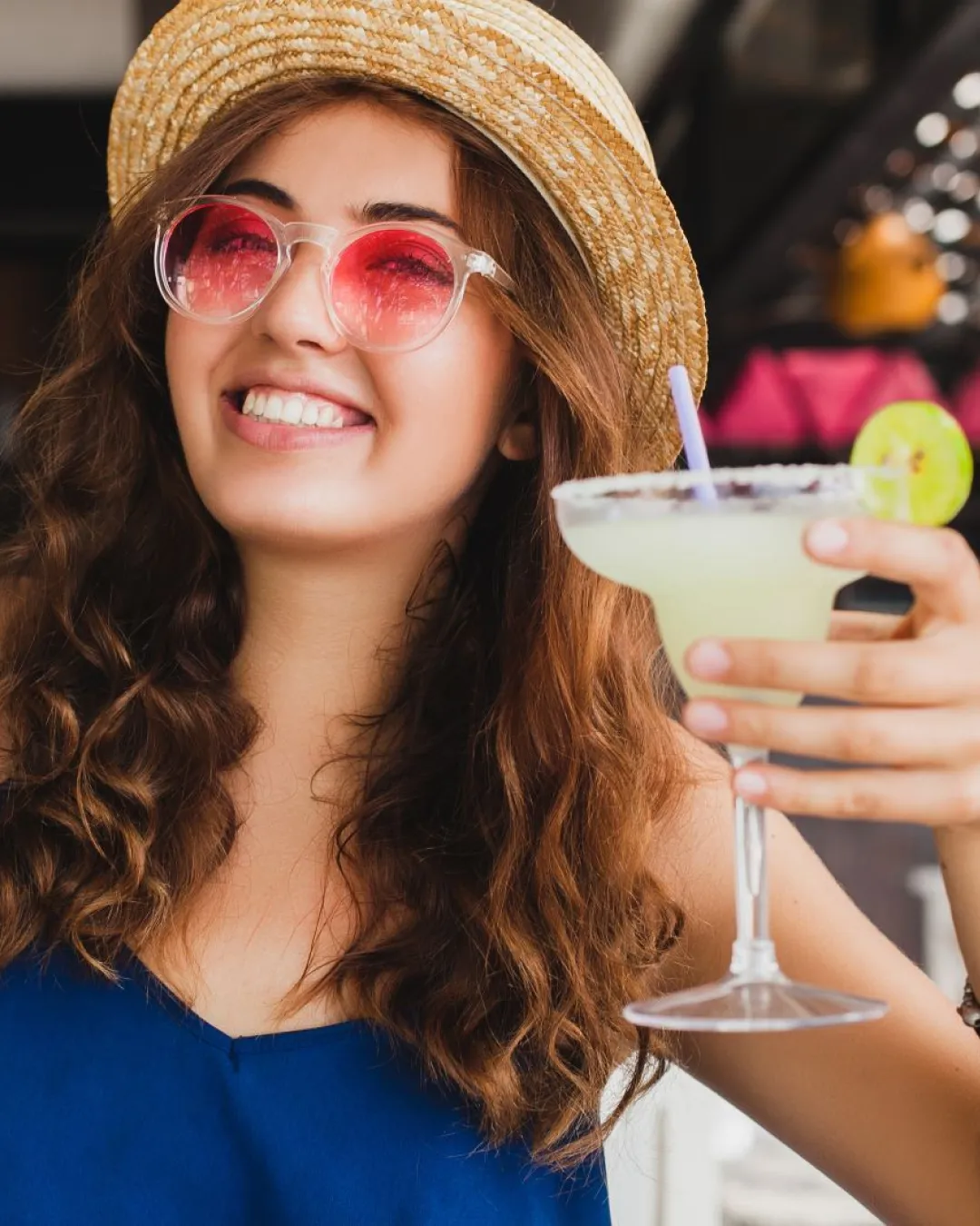 Young lady in spectacular sombrero enjoys tacos and  tequila shots at the cinco de mayo bar crawl

