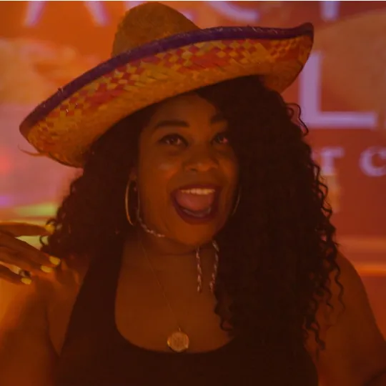 Solo dancer in chic attire and a sombrero hat, moving with unmatched grace and energy to the club's pulsating beats during the tacos and tequila cinco de mayo bar crawl event